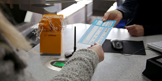 Eine Bordkarte wird übergeben